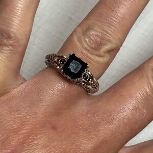 Fashion silver tone ring with black stone. Size 7. No markings